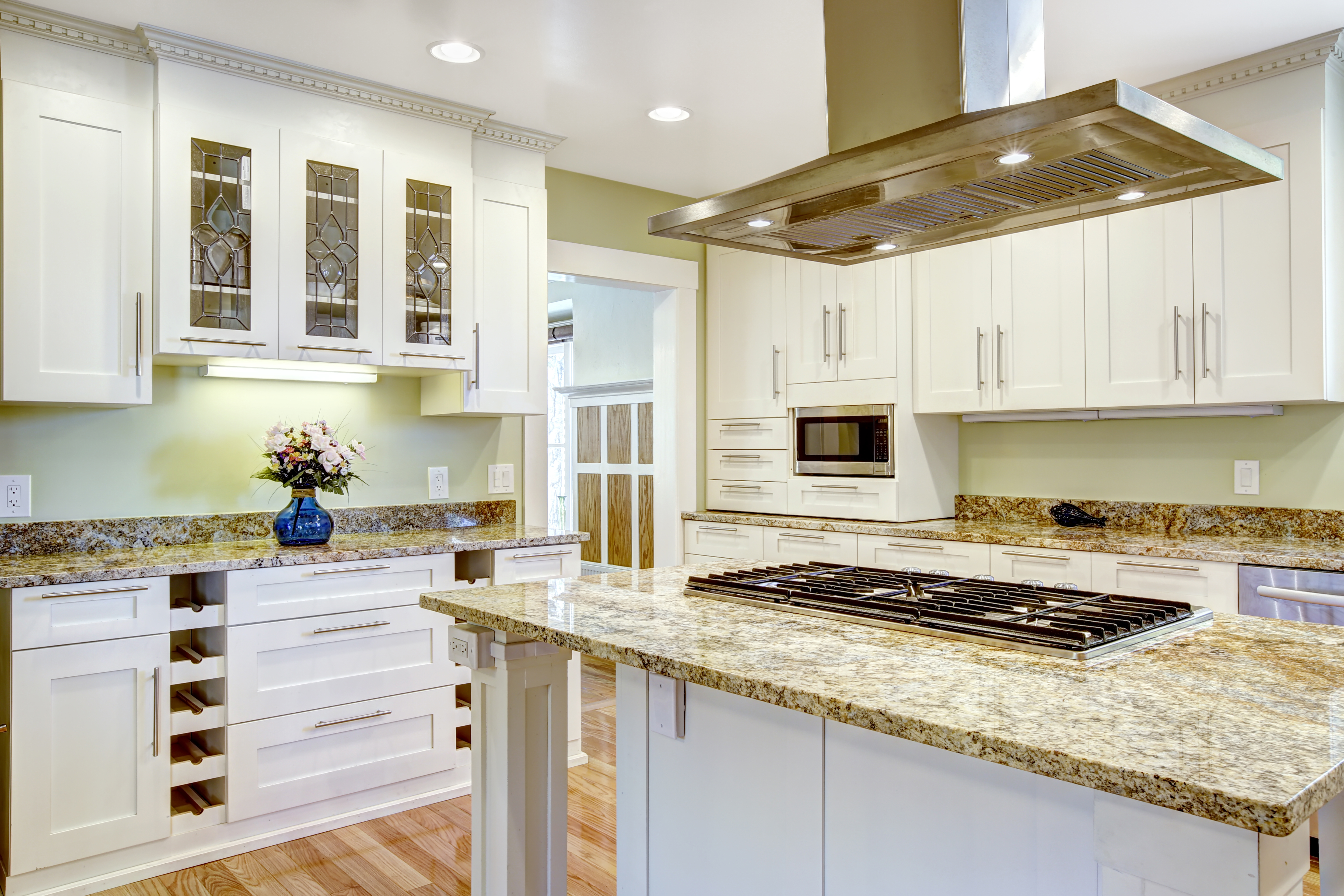 Kitchen island with built-in stove, granite top and hood